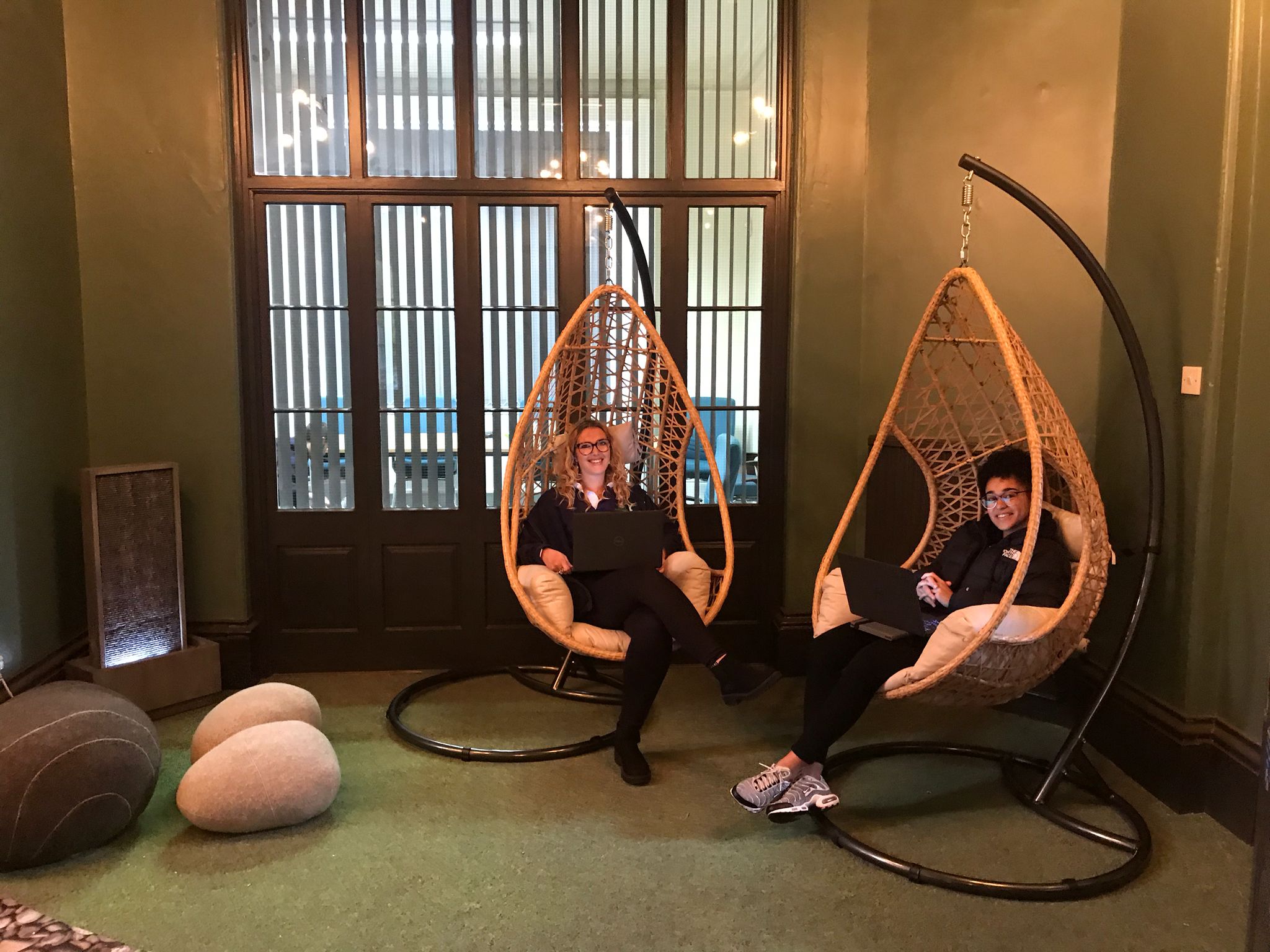 people sitting in swing seats