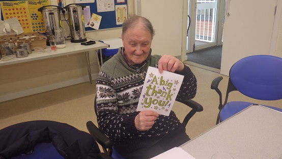 Person holding up a thank you card