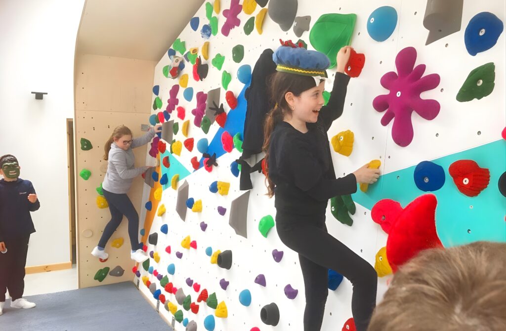 Young people using a climbing wall
